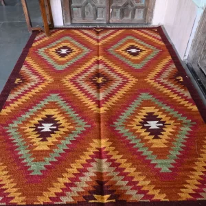 reddish-orange wool dhurrie rug flatweave texture