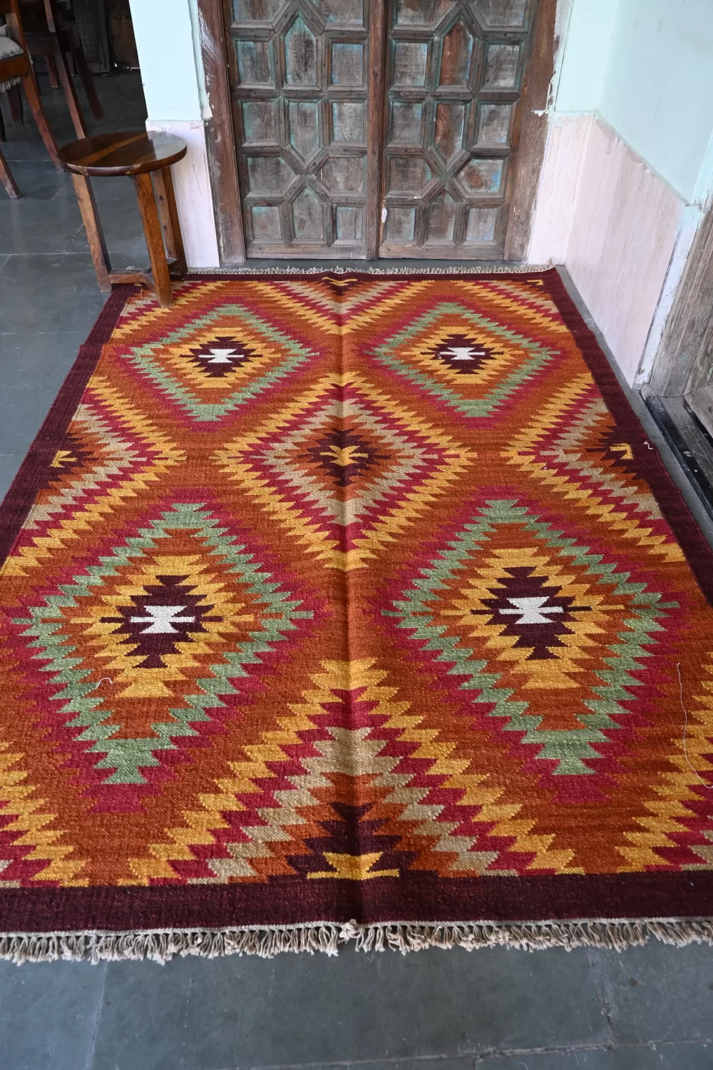 reddish-orange wool dhurrie rug flatweave texture
